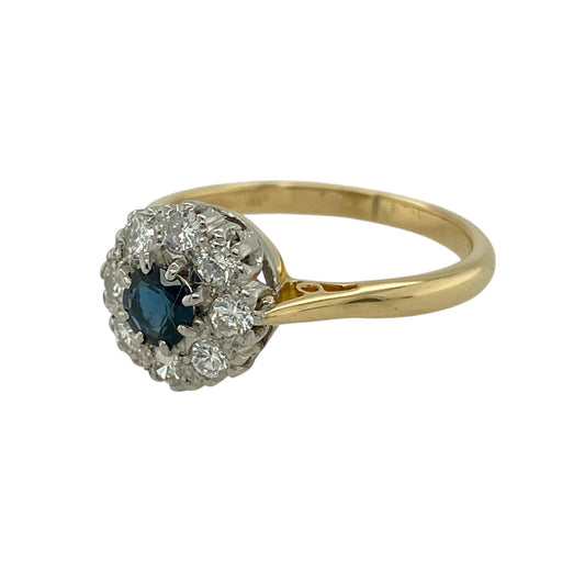 Add timeless elegance and rich colour to your jewellery collection with this pre-owned 18ct yellow gold diamond and sapphire cluster ring, featuring classic gemstones and refined sparkle—perfect for everyday luxury or a special occasion piece.
Design: The ring showcases a beautiful round sapphire at the centre measuring approximately 4mm in diameter, surrounded by a cluster of sparkling diamonds.