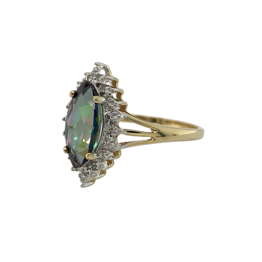 Add vibrant colour and elegant sparkle to your jewellery collection with this pre-owned 9ct yellow gold diamond and mystic topaz ring, featuring a striking gemstone and refined design—perfect as a statement dress ring or unique everyday piece.
Design: The ring showcases a marquise cut mystic topaz measuring approximately 12mm by 6mm, creating a bold and eye-catching focal point with beautiful flashes of colour.
