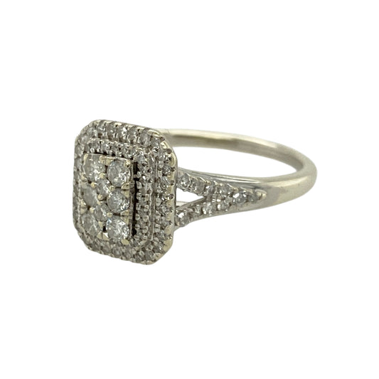 Make a statement with this pre-owned 9ct white gold diamond set rectangle cluster ringβan eye-catching and elegant piece designed to maximise sparkle and presence.
Design: This ring features a rectangular cluster of diamonds, creating a bold and structured look with impressive brilliance. The 11mm high front gives the ring a striking and substantial appearance on the finger.