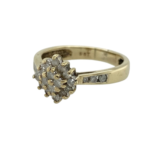 Add timeless sparkle and elegant detail to your jewellery collection with this pre-owned 9ct yellow gold diamond set cluster ring—an eye-catching piece perfect for everyday wear or special occasions.
Design: This ring features a 7mm high cluster front, set with sparkling diamonds that create a bright and balanced focal point, with additional diamonds set along the shoulders for enhanced brilliance.