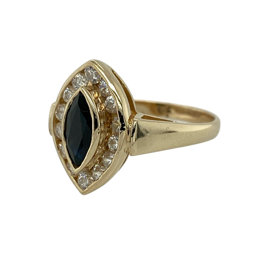 Add a touch of classic glamour to your jewellery collection with this pre-owned 9ct yellow gold sapphire and cubic zirconia marquise cluster ring, featuring a rich blue centre stone and sparkling surround—perfect for special occasions or elegant everyday wear.
Design: The ring features a marquise-shaped sapphire measuring approximately 8mm by 4mm at its centre, surrounded by a cluster of cubic zirconia stones that enhance its brilliance and create a striking elongated silhouette.