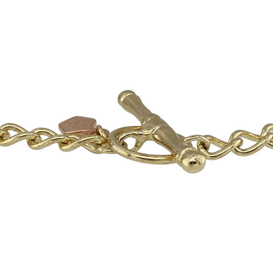 Add heritage style to your jewellery collection with this pre-owned 9ct yellow gold Clogau curb charm bracelet, featuring a classic design with a traditional T-bar fasteningβperfect for everyday wear or showcasing your favourite charms.
Design: The bracelet features a timeless curb link design, offering a smooth, flat profile that sits comfortably on the wrist while catching the light with subtle shine.