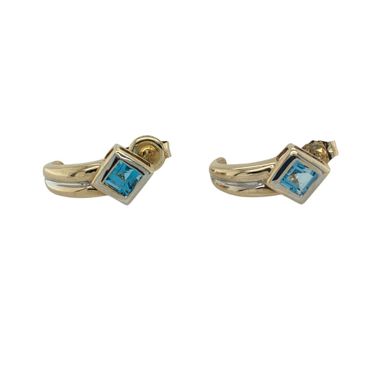 Add a fresh pop of colour and contemporary elegance to your collection with these pre-owned 9ct yellow and white gold blue topaz curved stud earrings—perfect for everyday wear with a subtle touch of sparkle.
Design: The earrings feature a gently curved design, each set with a 3mm by 3mm square blue topaz stone, offering a soft yet eye-catching blue hue with a modern twist.