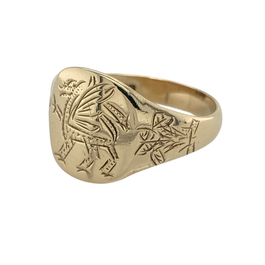 Celebrate heritage and bold design with this pre-owned 9ct yellow gold Welsh dragon signet ring—an eye-catching piece rich in symbolism and character.
Design: The ring features a striking signet face measuring approximately 14mm in height, showcasing a detailed Welsh dragon motif. The shoulders are engraved with the iconic Prince of Wales’s Feathers symbol, adding further historical significance and visual interest.