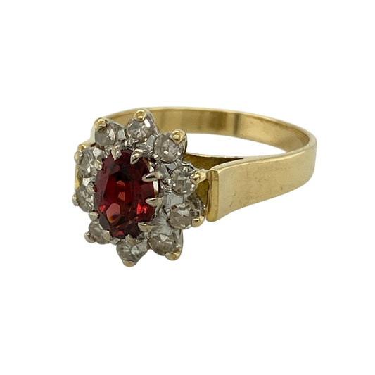 Bring rich colour and timeless elegance to your collection with this pre-owned 18ct yellow gold diamond and garnet cluster ring, featuring a striking design with refined sparkle—perfect for special occasions or sophisticated everyday wear.
Design: The ring showcases a 7mm by 5mm oval garnet at the centre, surrounded by sparkling diamonds in a classic cluster arrangement that creates a bold and eye-catching look.