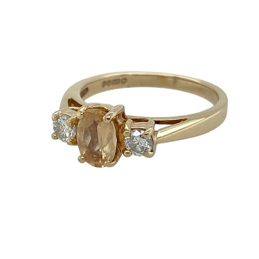 Add warm natural colour and timeless elegance to your jewellery collection with this pre-owned 14ct yellow gold diamond and golden brown beryl trilogy ring, featuring a classic three-stone design with delicate sparkle—perfect for special occasions, gifting, or sophisticated everyday wear.
Design: The ring showcases an elegant oval-cut golden brown beryl stone measuring approximately 7mm by 5mm, complemented by a sparkling diamond on either side to create a refined trilogy setting with balanced brilliance.