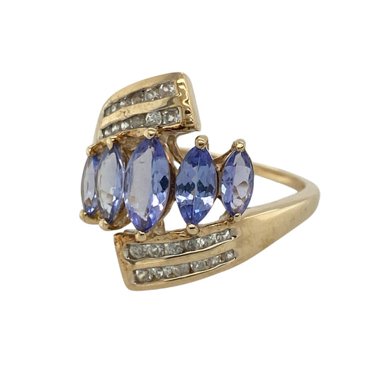 Add striking elegance and contemporary sparkle to your jewellery collection with this pre-owned 9ct yellow gold tanzanite and cubic zirconia wrap around ring, featuring an eye-catching statement design with beautiful colour and brilliance—perfect for special occasions, evening wear, or standout everyday styling.
Design: The ring features an elegant wrap around design measuring approximately 19mm high at the front, showcasing marquise-cut tanzanite stones complemented by sparkling cubic zirconia accents.