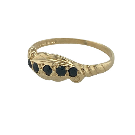 Add vintage-inspired elegance to your jewellery collection with this pre-owned 9ct yellow gold sapphire five stone band ring, featuring intricate scroll detailing and timeless gemstone appeal—perfect for special occasions, gifting, or sophisticated everyday wear.
Design: The ring showcases five beautiful sapphires set across the front of the band, framed by elegant scroll pattern detailing that creates a distinctive vintage-inspired appearance.