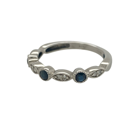 Add timeless elegance and rich colour to your jewellery collection with this pre-owned 9ct white gold diamond and sapphire band ring, featuring a classic gemstone design with refined everyday appeal—perfect for special occasions, gifting, or sophisticated daily wear.
Design: The ring features a beautifully balanced arrangement of sparkling diamonds and vibrant sapphires across the front of the band, creating an elegant display of colour and brilliance.