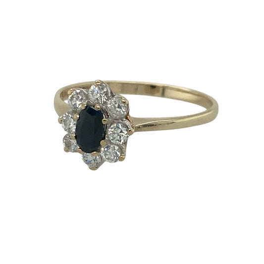 Add timeless elegance and rich colour to your jewellery collection with this pre-owned 9ct yellow gold sapphire and cubic zirconia cluster ring, featuring a classic gemstone design with refined everyday appeal—perfect for special occasions, gifting, or sophisticated daily wear.
Design: The ring showcases a beautiful oval sapphire measuring approximately 5mm by 3mm, surrounded by sparkling cubic zirconia stones in an elegant cluster setting.