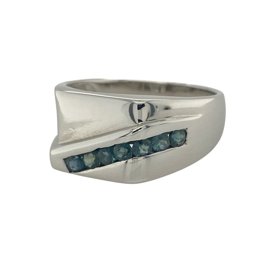 Make a bold and sophisticated statement with this pre-owned 9ct white gold sapphire signet ring. Combining the timeless appeal of a traditional signet ring with the striking beauty of deep blue sapphire-coloured stones, this impressive piece offers both elegance and individuality.
Design: The ring features a substantial signet-style face measuring approximately 11mm in height, set with seven sapphire-coloured blue stones.