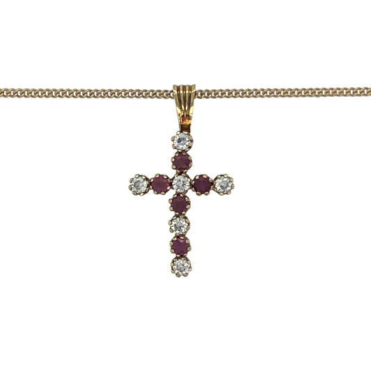 Elegant and meaningful, this pre-owned 9ct yellow gold ruby and cubic zirconia cross pendant necklace beautifully combines timeless Christian symbolism with vibrant colour and sparkling brilliance. Suspended from a classic curb chain, it is a graceful piece suitable for everyday wear or special occasions.
Design: The necklace features a classic cross pendant measuring approximately 2.2cm in length, including the bail.