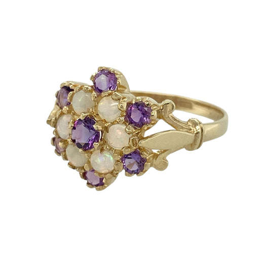Add beautiful colour and vintage-inspired elegance to your jewellery collection with this pre-owned 9ct yellow gold amethyst and Opalique cluster ring, featuring a striking floral-inspired cluster design—perfect for special occasions or everyday wear.
Design: The ring showcases a beautiful cluster arrangement measuring approximately 14mm across the front, combining rich purple amethyst with shimmering Opalique stones to create a striking and elegant focal point.