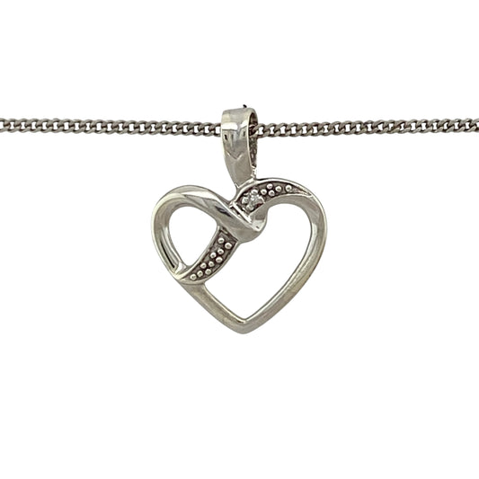Add romantic symbolism and delicate sparkle to your jewellery collection with this pre-owned 9ct white gold and diamond open heart pendant necklace, featuring an elegant design with timeless appeal.
Design: The necklace showcases a graceful open heart pendant enhanced with diamond detailing and suspended from a classic 18-inch curb chain, creating a romantic and versatile design suitable for everyday wear or special occasions.