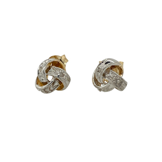 Add timeless elegance and refined sparkle to your jewellery collection with these pre-owned 9ct yellow and white gold diamond knot stud earrings, featuring a classic intertwined design with versatile two-tone styling.
Design: The earrings showcase an elegant knot design formed from intertwined yellow and white gold elements, creating an attractive sense of depth and movement enhanced with subtle diamond sparkle.