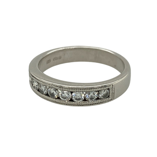 This pre-owned platinum diamond band ring combines timeless elegance with intricate milgrain detailing, making it a beautiful choice for everyday wear or as a wedding or anniversary band.
Design: The ring features a row of channel set diamonds across the front, complemented by delicate milgrain edge detailing that adds a vintage-inspired finish. The polished platinum setting enhances the brilliance of the diamonds while offering exceptional durability.
Material: Made from platinum.