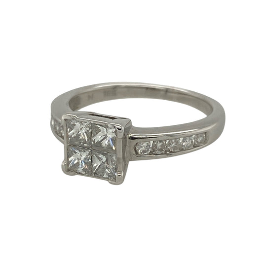 This pre-owned 18ct white gold diamond illusion set solitaire ring is an eye-catching design, expertly crafted to maximise brilliance and create the appearance of a larger centre stone.
Design: Featuring four princess cut diamonds set closely together to create the illusion of a single larger diamond, this elegant ring is further enhanced by brilliant cut diamonds adorning the shoulders.