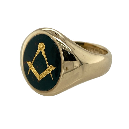 This pre-owned 9ct yellow gold bloodstone Masonic signet ring is a distinctive traditional design, featuring an oval bloodstone with Masonic detailing.
Design: Featuring an oval bloodstone within a traditional Masonic signet ring design, this ring is finished in warm 9ct yellow gold.
Material: Made from 9-carat yellow gold.
Gemstone Detail: Oval bloodstone measuring approximately 11mm by 9mm.
Ring Detail: Masonic oval signet ring design.
Size & Weight: Ring size K. Total weight 5.50 grams.
