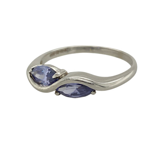 This pre-owned 9ct white gold tanzanite twist band ring is a distinctive gemstone design, featuring two marquise cut tanzanite stones within a flowing twist setting.
Design: Featuring a twist-style band set with two marquise cut tanzanites, this ring combines rich blue-purple tones with the bright finish of 9ct white gold.
Material: Made from 9-carat white gold.
Gemstone Detail: Two marquise cut tanzanite stones, each measuring approximately 8mm by 4mm.
Ring Detail: Two-stone twist band ring design.