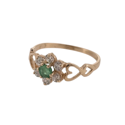 Add a colourful and charming piece to your jewellery collection with this pre-owned 9ct yellow gold green stone and cubic zirconia cluster ring, featuring decorative heart cut-outs along the shoulders.
Design: The ring features a classic cluster design, combining a green stone with cubic zirconia detailing and heart-shaped cut-outs on the shoulders.
Material: Made from 9ct yellow gold, offering a traditional warm gold finish.