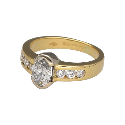 Add an impressive diamond piece to your jewellery collection with this pre-owned 18ct yellow gold solitaire-style ring, featuring a rubover-set oval diamond with additional brilliant-cut diamonds along the shoulders.
Design: The ring features a central oval diamond in a rubover setting, complemented by three brilliant-cut diamonds on each shoulder for a total of six additional diamonds.