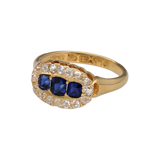 Bring vintage elegance and timeless sparkle to your collection with this pre-owned 18ct yellow gold trilogy cluster ring, featuring sapphires and diamonds in a classic design.
Design: The ring showcases three cushion-cut sapphires at the centre, framed by surrounding diamonds in a refined cluster style that enhances both colour and brilliance.
Material: Made from 18-carat yellow gold, the polished finish enriches the warm tone and contrasts beautifully with the deep blue sapphires and bright diamonds.