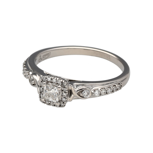 Bring sparkle and sophistication to your collection with this pre-owned 18ct white gold princess cut halo diamond ring, a timeless style full of brilliance.
Design: The ring features a princess cut diamond at the centre, framed by a halo of diamonds and further enhanced with diamond-set shoulders for extra radiance.
Material: Made in 18-carat white gold, the polished finish offers a bright, modern backdrop that enhances the diamonds’ fire and sparkle.