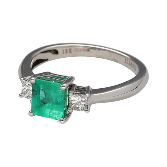Bring vibrant colour and timeless elegance to your collection with this pre-owned 18ct white gold diamond and emerald trilogy cocktail ringβa striking design that perfectly balances sophistication and sparkle.
Design: The ring features a vivid square-cut emerald at the centre, flanked by two princess-cut diamonds of approximately 0.18ct each. The trilogy arrangement symbolises the past, present, and future, while the contrasting gemstones create a refined and eye-catching look.
