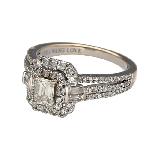 Bring exceptional luxury and iconic designer elegance to your jewellery collection with this pre-owned 18ct white gold diamond set Vera Wang cluster halo ring, a breathtaking statement piece with exquisite detail.
Design: The ring features a striking emerald-cut diamond at the centre, surrounded by a halo of baguette and brilliant-cut diamonds, creating a sophisticated and radiant cluster effect. The band is split into three diamond-set rows, adding depth, brilliance, and a bold architectural presence.
