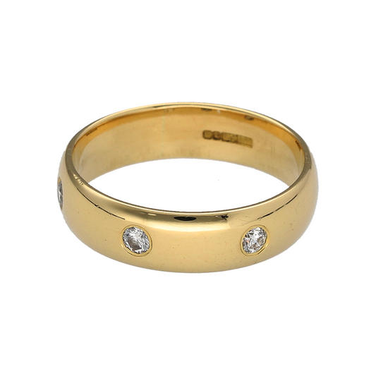 Add classic sparkle and elegant meaning to your jewellery collection with this pre-owned 18ct yellow gold diamond trilogy band ring, offering timeless design with refined brilliance.
Design: This band ring features a trilogy arrangement across the front, with three diamonds displayed along a 5mm wide band to create a balanced and elegant look.
Material: Made from luxurious 18-carat yellow gold, the warm polished finish beautifully complements the sparkle of the diamonds and enhances the classic styling.