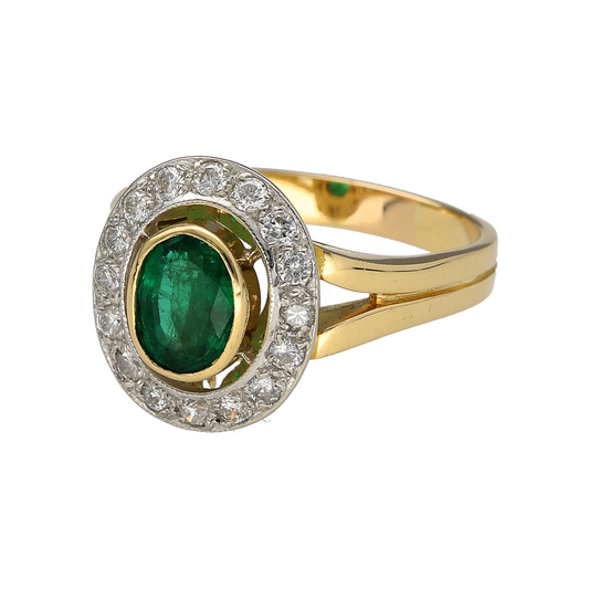 Bring refined luxury and vibrant colour to your collection with this pre-owned 18ct yellow gold diamond and emerald halo ring, combining timeless design with striking brilliance—perfect for elegant occasions or treasured everyday wear.
Design: The ring showcases a captivating 8mm by 6mm oval-cut emerald at the centre, surrounded by a sparkling halo of diamonds totalling approximately 0.48ct, creating a radiant frame that enhances the emerald’s vivid green hue.