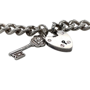 Preowned 925 Silver 7.5" Charm Bracelet with a 21 key charm, heart padlock and safety chain. The bracelet has the weight 36.50 grams and link width 9mm
