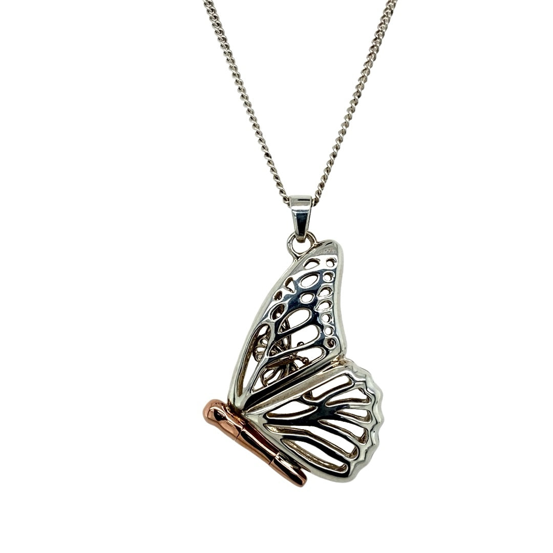 Bring whimsical beauty and heartfelt symbolism to your collection with this pre-owned 925 silver with 9ct rose Clogau gold butterfly locket pendant on an 18" Clogau curb chain, blending elegant craftsmanship with a touch of wonder—perfect for gifting or treasured keepsakes.

Design: The 3.5cm long pendant (including the bail) features an intricately shaped butterfly in sterling silver with rose gold accents. Inside, a smaller butterfly is revealed when the locket opens, symbolising transformation