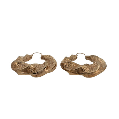 Make a statement with these pre-owned 9ct yellow gold fancy leaf twist pattern creole earrings, featuring decorative detailing and a bold oversized design.

Design: The earrings feature a large creole shape with an intricate leaf-inspired twist pattern, creating a textured and decorative finish with plenty of visual detail.
Material: Made from 9-carat yellow gold, the warm gold tone enhances the patterned design and gives these earrings a classic yet distinctive appearance.