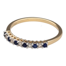 Load image into Gallery viewer, Bring timeless elegance and rich colour to your collection with this new 9ct yellow gold diamond and sapphire set band ring, offering a refined blend of classic sparkle and vibrant detail—perfect for adding a luxurious touch to any look.

Design: The ring features alternating sapphire stones, each approximately 1.5mm in diameter, and shimmering diamonds with a total diamond content of approximately 0.12ct, creating a beautifully balanced and eye-catching pattern across the band.

