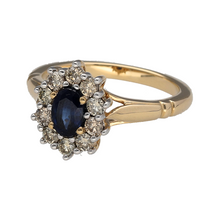 Load image into Gallery viewer, New 9ct Yellow and White Gold Diamond &amp; Sapphire Set Cluster Ring in size M. The front of the ring is 13mm high and the sapphire stone is approximately 6mm by 4mm. There is approximately 0.50ct of real natural diamonds set in the cluster in total. The diamonds are approximate clarity i1 and colour K - M
