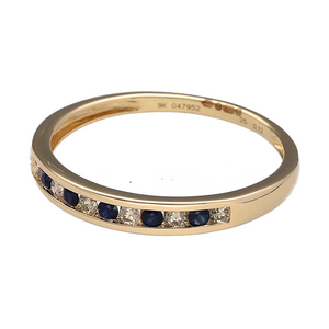 Bring refined sparkle and rich colour to your collection with this new 9ct yellow gold diamond and sapphire set band ring—perfect for elegant everyday wear or meaningful gifting.

Design: The 3mm wide band features a sleek row of channel-set sapphires and diamonds, offering a smooth, modern profile with classic contrast.
Material: Made from 9-carat yellow gold, the polished finish enhances the deep blue sapphires and the brilliance of the diamonds.
