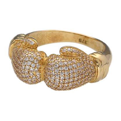 Bring bold impact and champion style to your collection with this new 9ct yellow gold and cubic zirconia set double boxing glove ring—a powerful design that symbolises strength, determination, and pride.

Design: The ring features a striking 12mm high front with two detailed boxing gloves facing each other, accented with sparkling cubic zirconia to highlight the form and add eye-catching brilliance.
