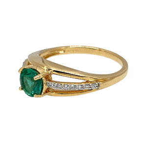 Preowned 18ct Yellow Gold Diamond & Green Stone Set Ring in size N with the weight 3.70 grams. The green stone is 6mm diameter and the band is split with diamonds on the center band