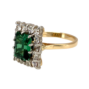Preowned 9ct Yellow and White Gold Green Stone & Cubic Zirconia Set Dress Ring in size N with the weight 5 grams. The green emerald coloured stone is 9mm by 7mm