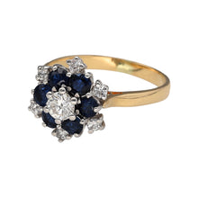 Load image into Gallery viewer, Preowned 18ct Yellow and White Gold Diamond &amp; Sapphire Set Cluster Ring in size N with the weight 4.10 grams. The sapphire stones are each 3mm diameter and the center diamond is approximately 25pt with six smaller diamonds on the outside of the cluster
