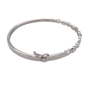 Preowned 9ct White Gold & Cubic Zirconia Set Oval Hinged Bangle with the weight 8.30 grams. The bangle diameter is 6cm and the stones are each approximately 5mm by 2.5mm 