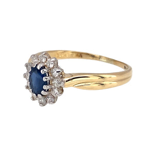Preowned 18ct Yellow and White Gold Diamond & Sapphire Set Cluster Ring in size P with the weight 2.90 grams. The sapphire stone is 6mm by 4mm and there is approximately 25pt of diamond content in total