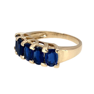 Preowned 9ct Yellow Gold & Blue Stone Set Band Ring in size N with the weight 4.20 grams. The blue stones are each 6mm by 4mm