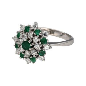 Preowned 18ct White Gold Diamond & Emerald Set Cluster Ring in size O with the weight 5.60 grams. The front of the ring is 17mm high and the emerald stones are either 4mm diameter or 2mm diameter. There is approximately 56pt of diamond content