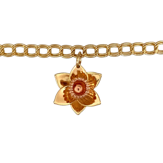 Preowned 9ct Yellow and Rose Gold Clogau 7.25" Curb Charm Bracelet with a daffodil charm. The bracelet has the weight 6.40 grams and link width 4mm. The daffodil charm is approximately 2cm including the bail by 1.5cm