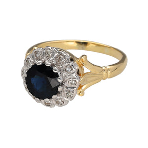 Preowned 18ct Yellow and White Gold Diamond & Sapphire Set Cluster Ring in size O with the weight 4.40 grams. The sapphire stone is 7mm diameter