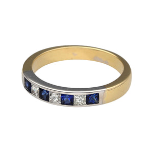 Preowned 18ct Yellow and White Gold Diamond & Sapphire Set Band Ring in size N with the weight 4.40 grams. The band is 3mm wide at the front and the sapphire stones are each 2mm by 2mm
