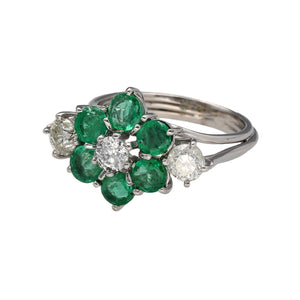 Preowned 18ct White Gold Diamond & Emerald Set Flower Cluster Ring in size N with the weight 6.60 grams. There are three diamond at approximately 25pt each so there is a total of approximately 75pt of diamond content in total. There are six emerald stones at approximately 4mm diameter each