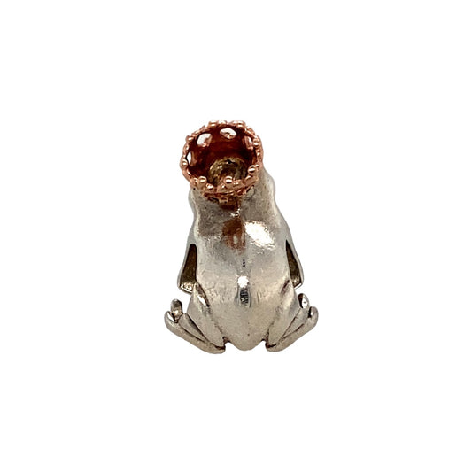 Add a whimsical touch of nature and heritage to your collection with this pre-owned 925 silver and 9ct rose gold Clogau frog charm—playful, detailed, and full of character.

Design: This charming piece features a finely detailed frog in polished sterling silver, accented with 9ct Welsh rose gold for a soft contrast and a signature Clogau touch.
Material: Crafted from 925 sterling silver with rare 9-carat Welsh rose gold detailing, the polished finish highlights the intricate textures and organic form.
